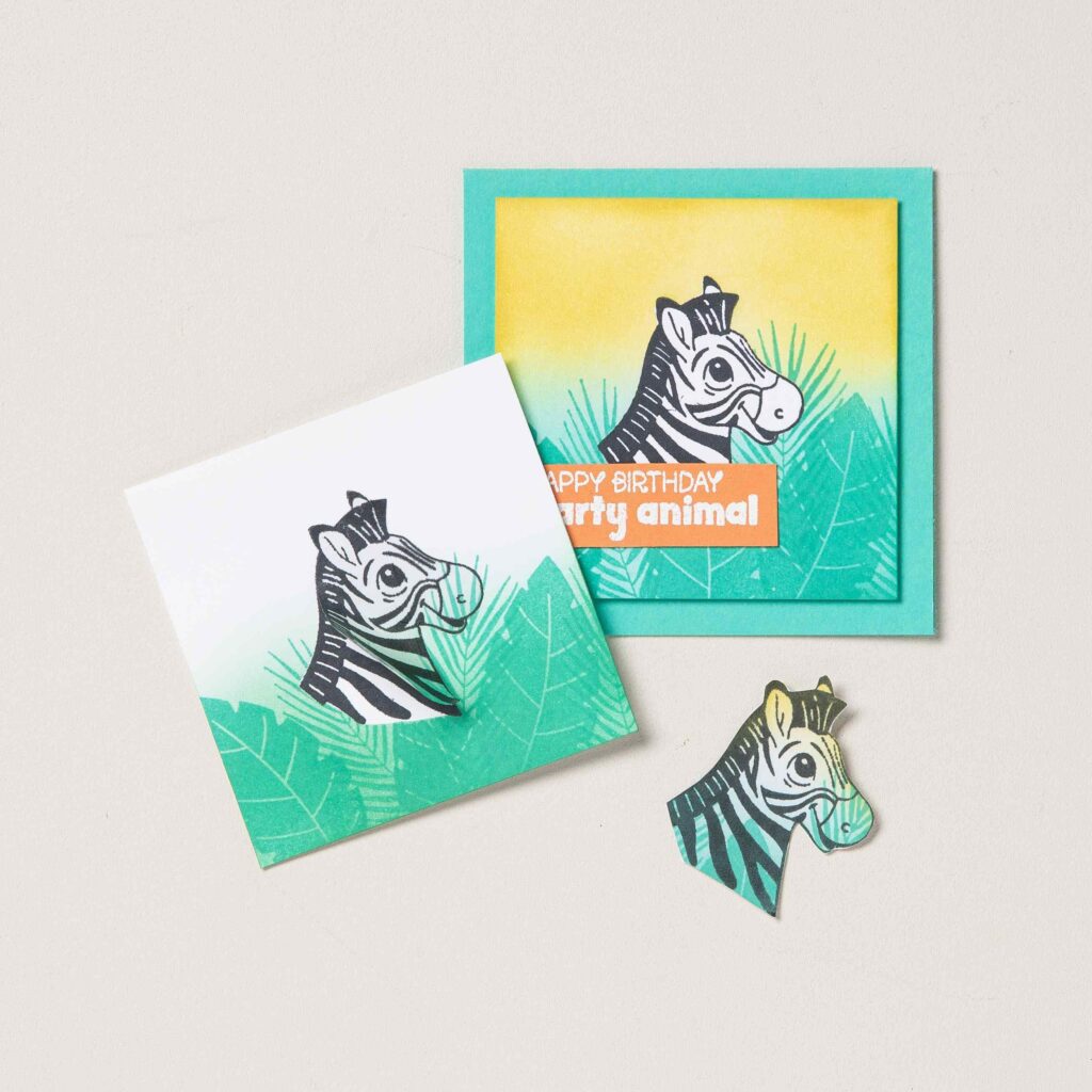 A finished handmade card demonstrates bold color blocking created with masking paper and blended ink backgrounds.