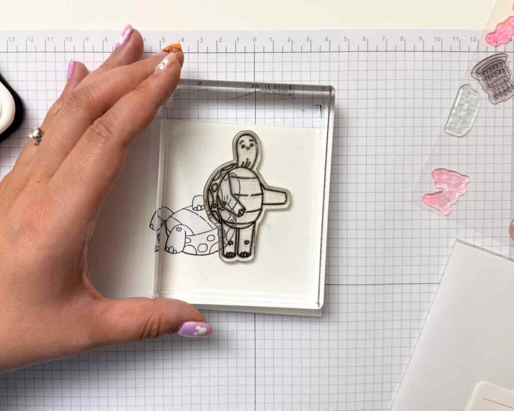 A second stamped image is layered behind the masked foreground image to create depth and dimension on cardstock.