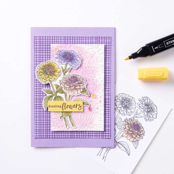 Floral stamped card created using clear stamps, ink, and an acrylic block on a grid sheet, showing step-by-step paper stamping techniques.