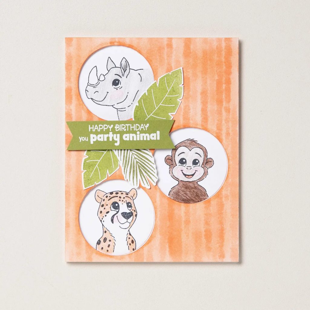 Handmade birthday card featuring illustrated jungle animals including a rhino, monkey, and cheetah with a "Happy Birthday you party animal" sentiment.