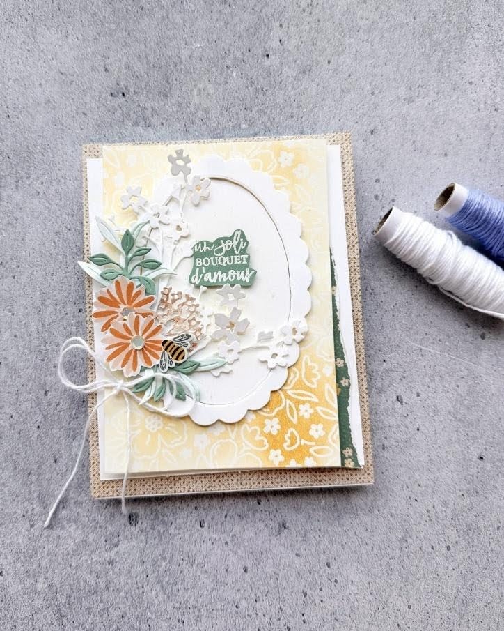 Handmade floral card with layered yellow paper, die-cut flowers, bee embellishment, and white twine