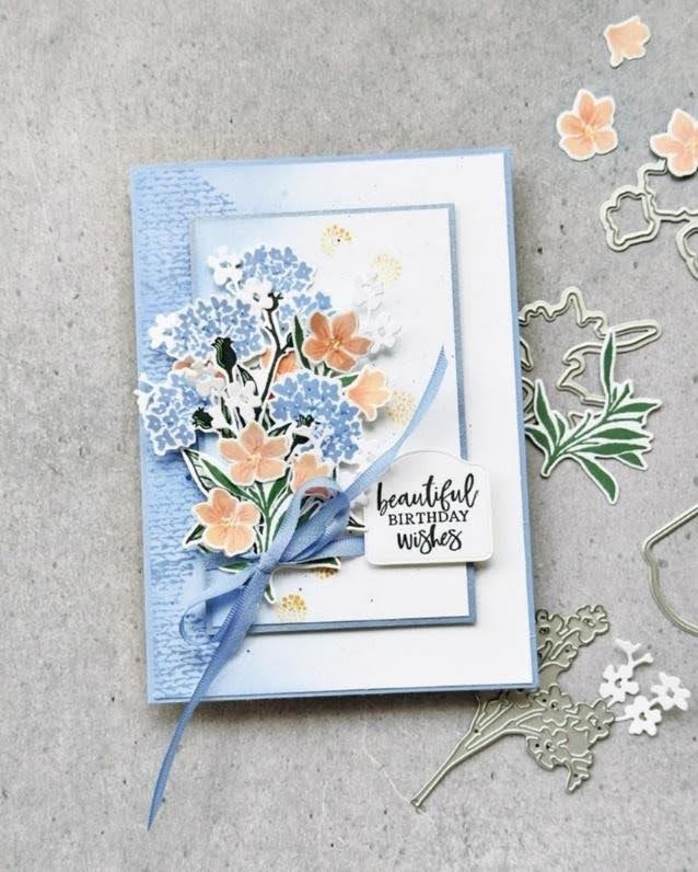 Handmade birthday card with layered blue and peach flowers created with floral dies