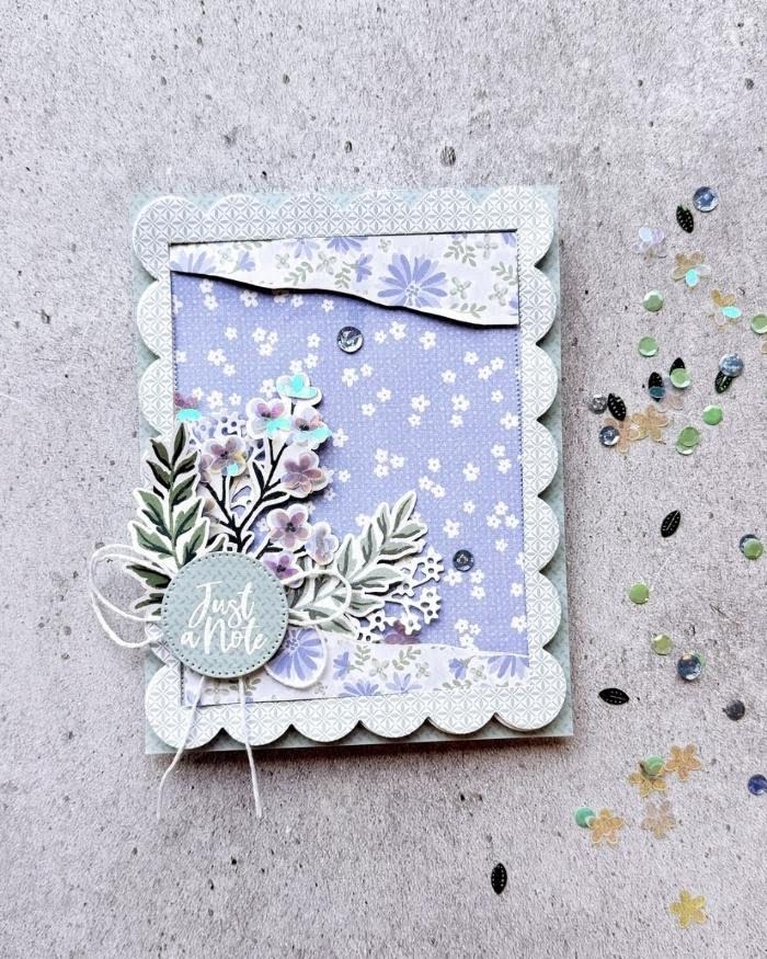 Purple floral Just a Note card with scalloped edges, layered greenery, twine, and loose embellishments