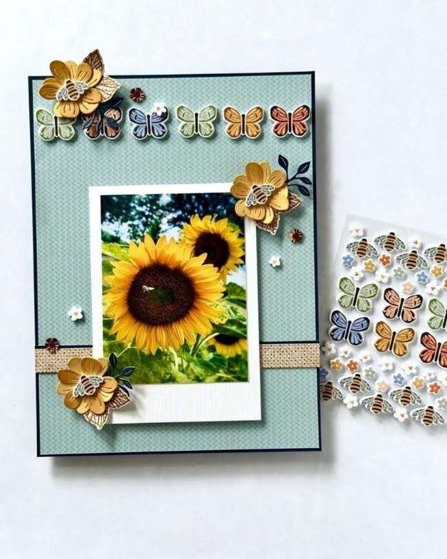 Handmade card featuring a sunflower photo with floral and butterfly embellishments