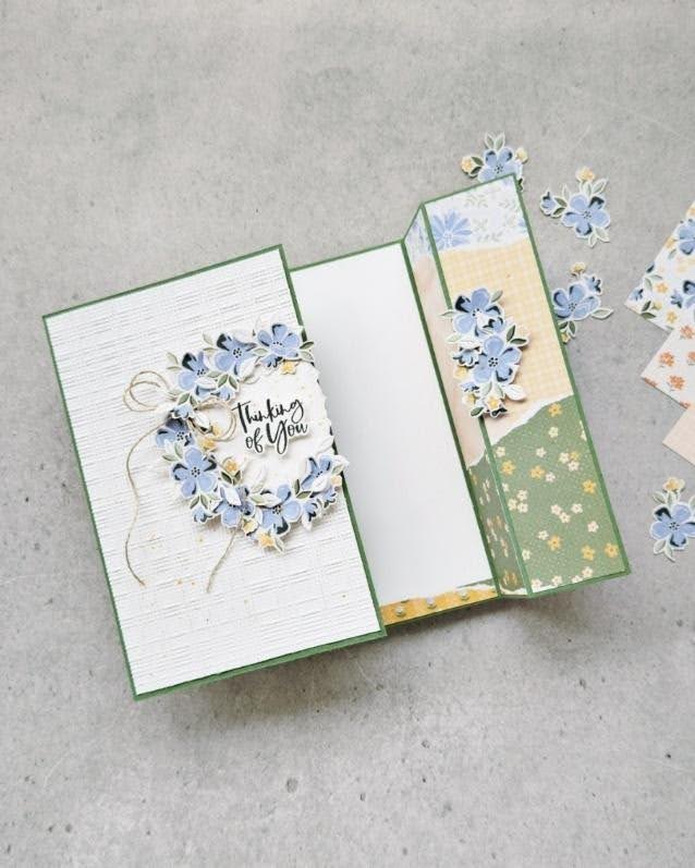 Fold-out Thinking of You card decorated with layered blue flowers and patterned paper